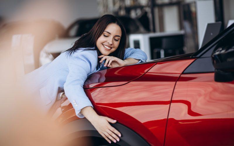 Woman,Hugging,Her,New,Red,Car