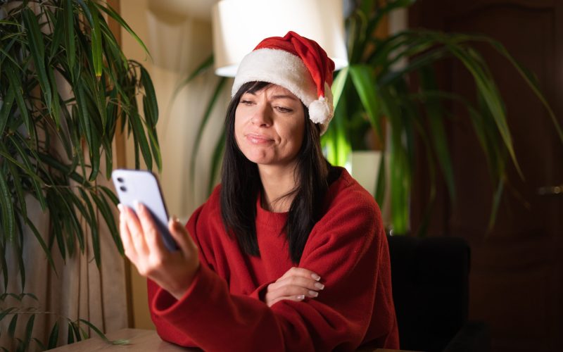 Annoyed,Young,Hipster,Woman,In,Santa,Claus,Hat,Looking,At