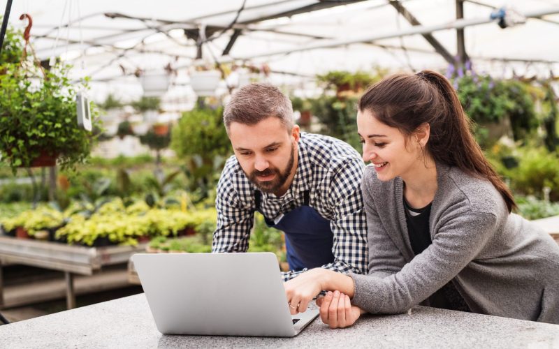 Female,Business,Owner,And,Gardener,Looking,At,Order,In,Laptop,
